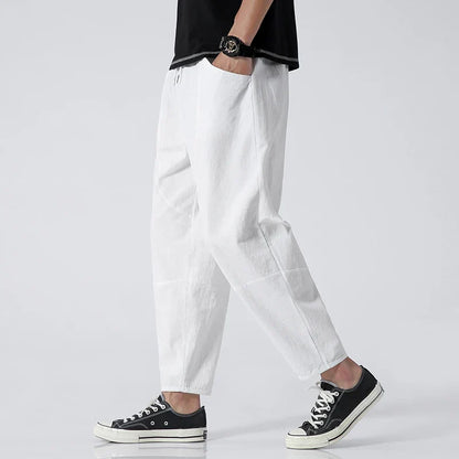 Modern men's relaxed fit cropped pants with a drawstring waist, perfect for comfortable summer wear.