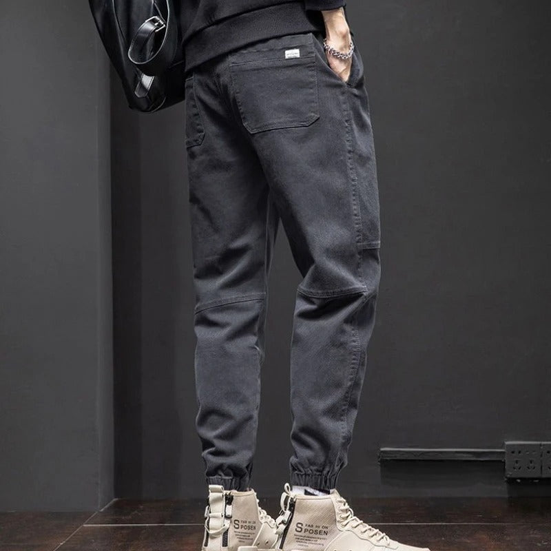 Black men's tapered leg joggers, relaxed fit with drawstring, great for activewear, casual comfort & lounging.