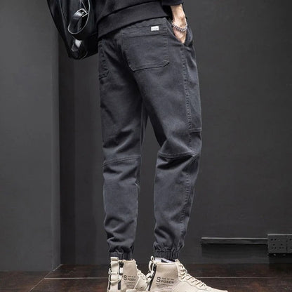 Black men's tapered leg joggers, relaxed fit with drawstring, great for activewear, casual comfort & lounging.