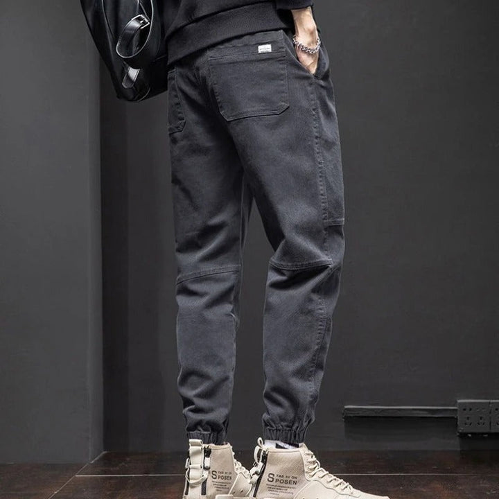 Black men's tapered leg joggers, relaxed fit with drawstring, great for activewear, casual comfort & lounging.