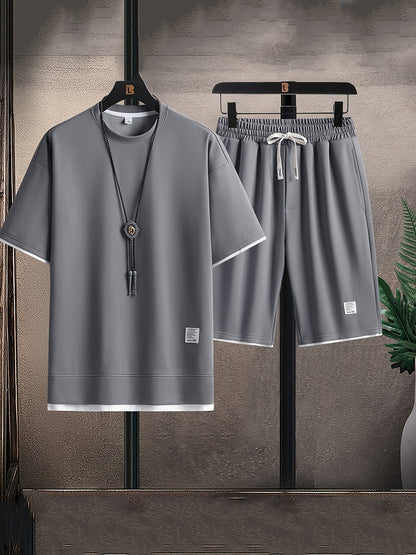 Men's relaxed fit two-piece lounge set with t-shirt & drawstring shorts. Comfortable, casual home wear.
