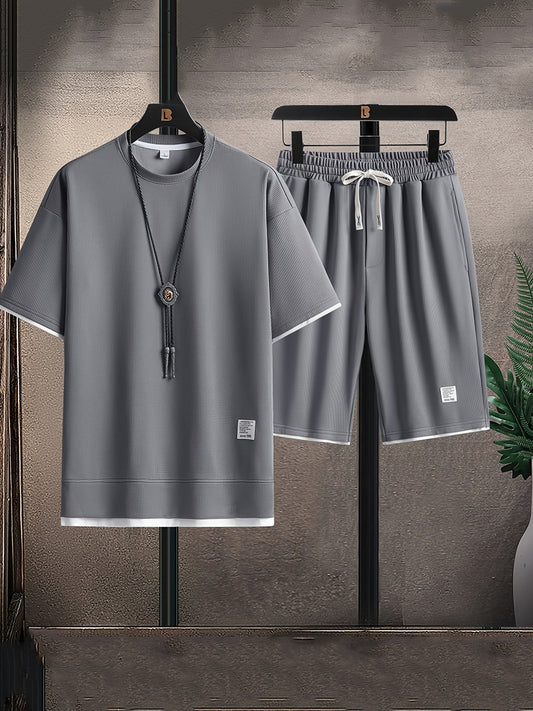 Men's relaxed fit two-piece lounge set with t-shirt & drawstring shorts. Comfortable, casual home wear.
