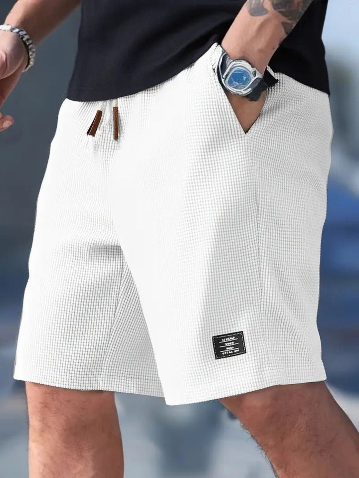 Men's waffle knit texture shorts, relaxed fit, drawstring for comfort & casual summer style.