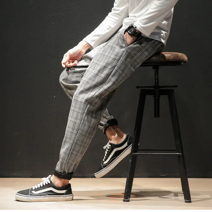 Close-up of the stylish plaid fabric and stretch waist detail on Men's Renegade Trousers.
