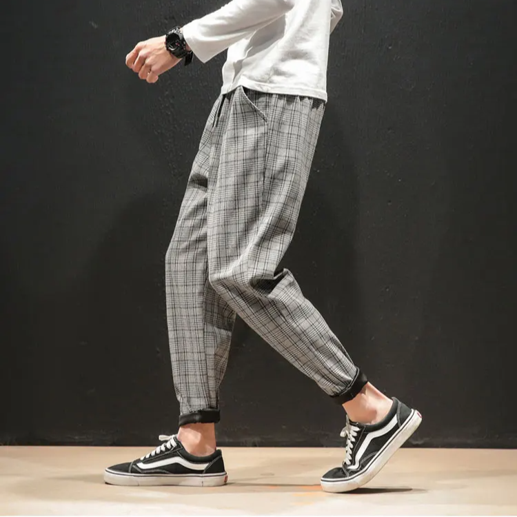Full length view of Men's Renegade Plaid Trousers, showcasing the modern tapered fit on a model.