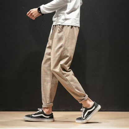 Detail shot of the drawstring and stretch waist on Men's Renegade Plaid Trousers, practical style.