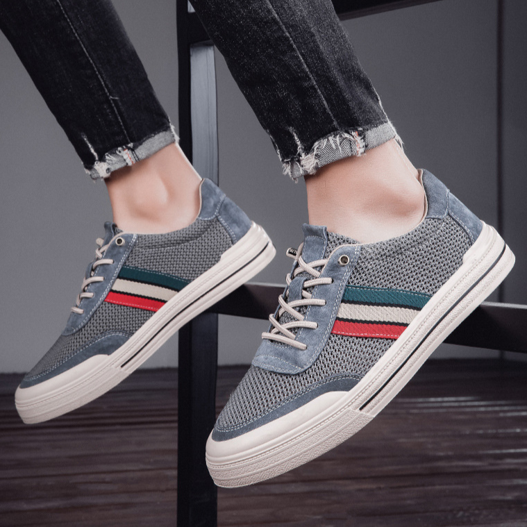 Close-up of men's retro comfort sneakers, highlighting lace-up detail & premium casual style.