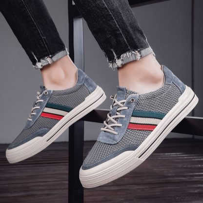 Close-up of men's retro comfort sneakers, highlighting lace-up detail & premium casual style.