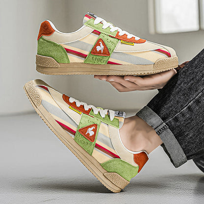 Men's streetwear sneakers, retro 80s track style with vibrant colors and grooved sole.