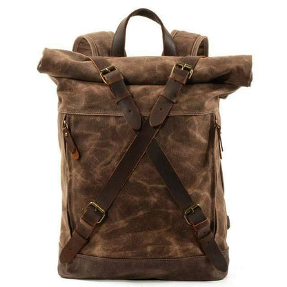 Waterproof cowhide outdoor survival backpack for men, against a natural background