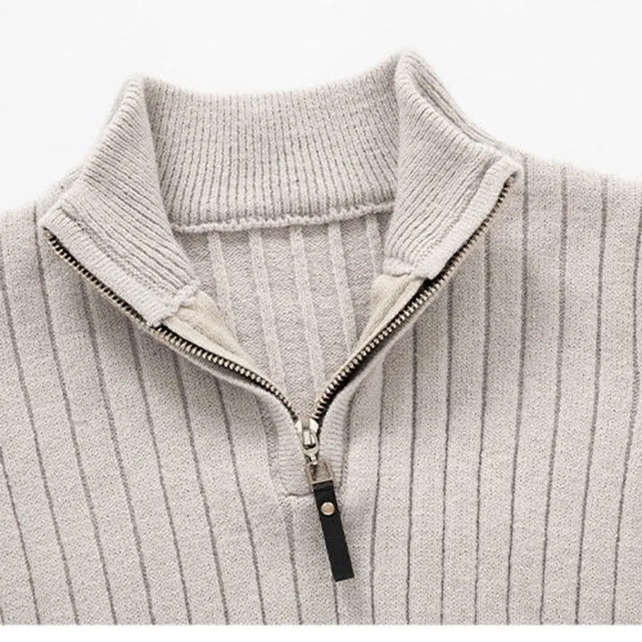 Close-up of men's ribbed half-zip sweater. Highlights sophisticated knit texture & quality menswear.
