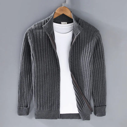 Close-up of men's full-zip ribbed knit sweater, highlighting cotton blend texture & quality zipper detail.