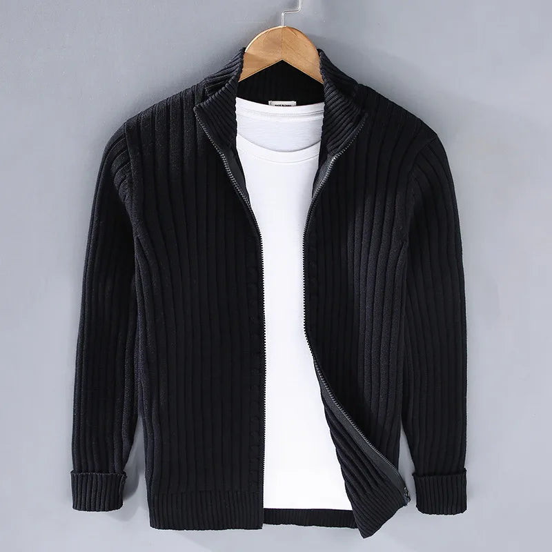 Model in elegant men's full-zip ribbed knit sweater. Classic cotton blend design, perfect for sophisticated layering.