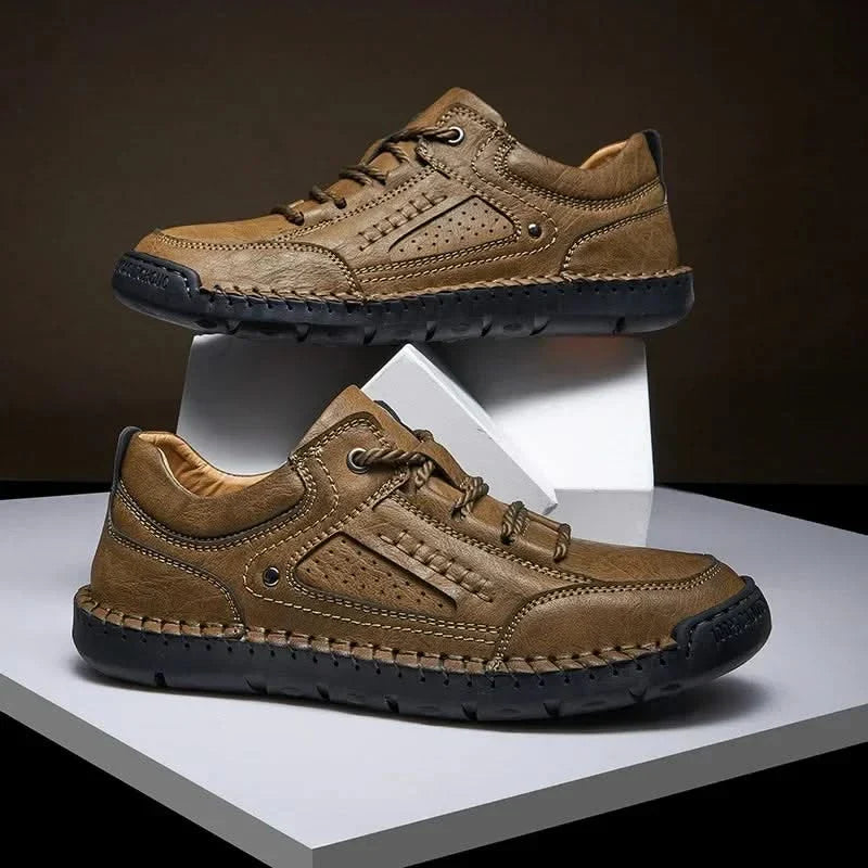 Front view of khaki men's all-terrain hiking shoes, with protective toe cap for rugged trails.