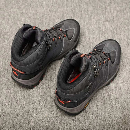 Pair of black men's hiking shoes with orange accents, ideal for walking and outdoor activities.