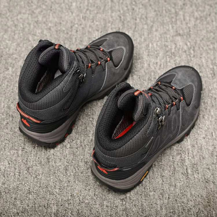 Pair of black men's hiking shoes with orange accents, ideal for walking and outdoor activities.