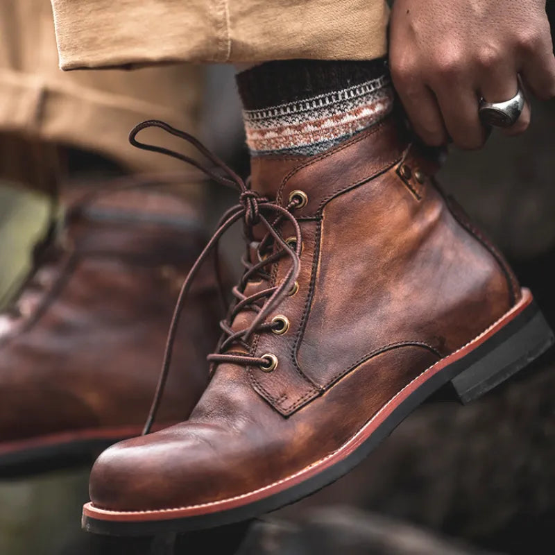 Men's Rugged Odyssey brown leather lace-up boots, durable and shock-resistant for everyday wear & outdoor adventures.