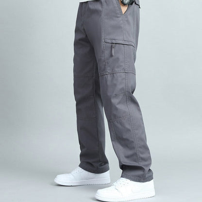 Man hiking in rugged outdoor cargo pants, showing practical multi-pockets and comfortable fit.