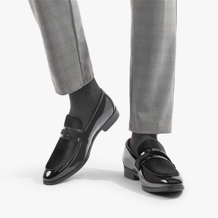 Black slip-on men's dress loafers, elegant formal footwear for professional or special events.