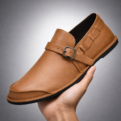 Close-up of men's sleek loafers featuring a stylish buckle detail. Offering comfort & polished elegance for versatile wear.