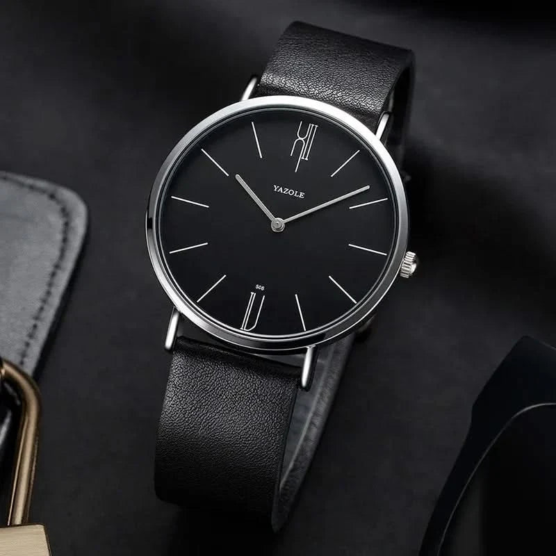 Close-up of men's minimalist dress watch, elegant black leather strap & silver stainless steel case.
