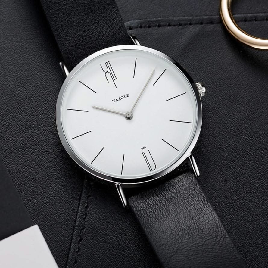 Men's minimalist dress watch on a wrist, showcasing its elegant leather strap & sleek design.