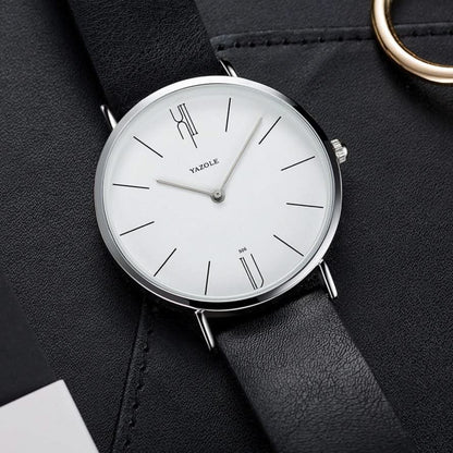 Men's minimalist dress watch on a wrist, showcasing its elegant leather strap & sleek design.