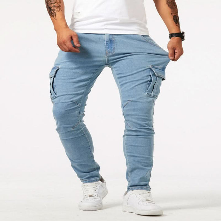 Close-up of side pockets on men's slim fit cargo jeans, highlighting utility design & durable denim.