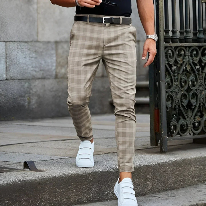 Man wearing slim fit cropped checked pants, highlighting the stylish tailored and modern design.