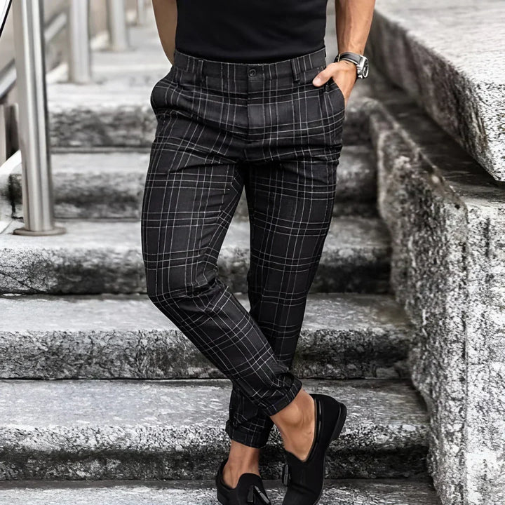 Comfortable slim fit men's checked trousers, cropped length, offering a contemporary and smart casual style.