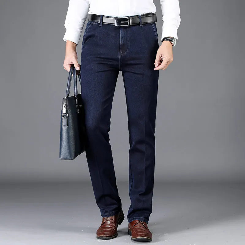 Man wearing casual blue slim fit denim trousers with stretch, paired with a t-shirt for everyday comfort.
