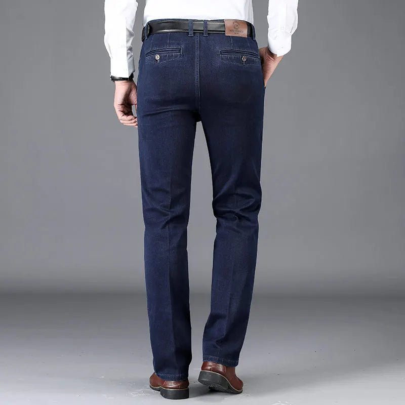 Stylish man in smart casual men's slim fit denim trousers with stretch, perfect for versatile fashion.