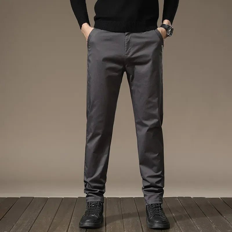 Man wearing sleek slim fit casual dress pants, enjoying wrinkle-free comfort and modern style.