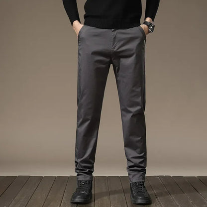 Man wearing sleek slim fit casual dress pants, enjoying wrinkle-free comfort and modern style.