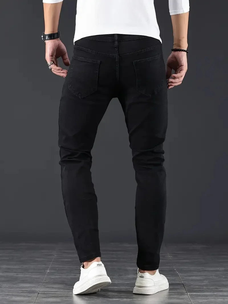 Stylish men's slim fit jeans with a modern tapered fit, ideal casual pants for a contemporary look.