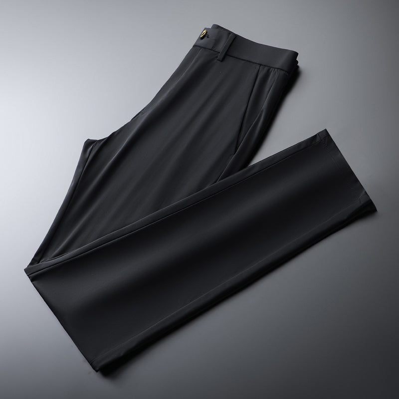 Man relaxing in army green slim fit performance pants, perfect for casual and versatile style.
