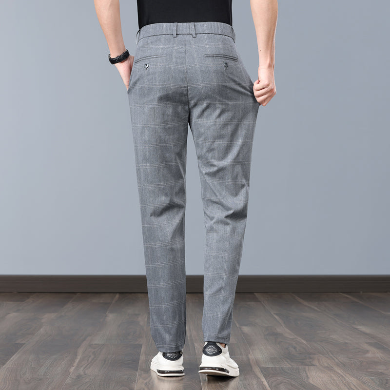 Close-up of men's slim fit plaid dress pants fabric, highlighting quality tailoring and comfort.