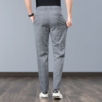Close-up of men's slim fit plaid dress pants fabric, highlighting quality tailoring and comfort.