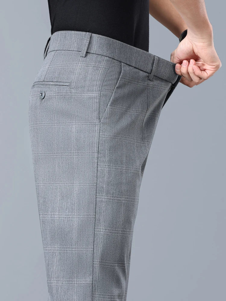 Man wearing modern slim fit plaid dress pants, ideal for a tailored business casual outfit.