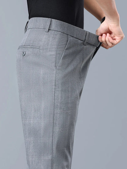 Man wearing modern slim fit plaid dress pants, ideal for a tailored business casual outfit.