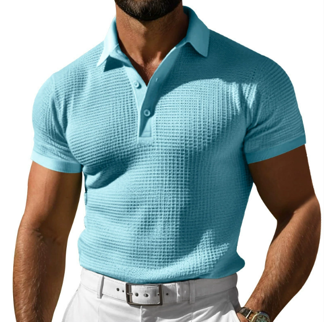 Close-up of a men's slim fit polo shirt, highlighting the unique textured point collar and short sleeve detail.