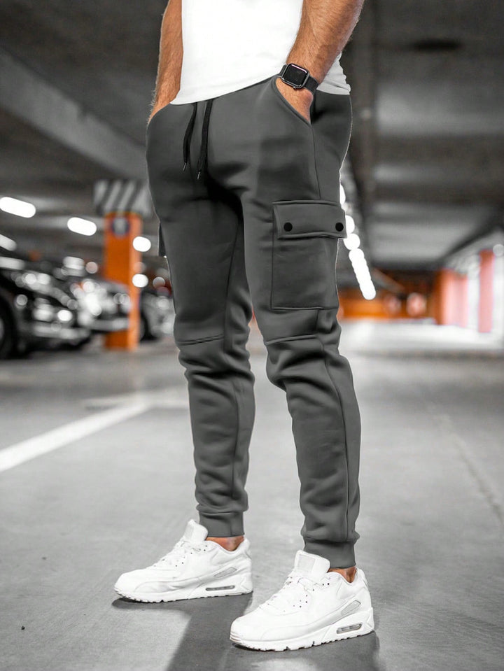 Men's slim-fit streetwear pants, black, modern comfort, tapered leg.