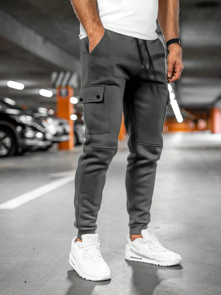 Stylish men's slim-fit cargo pants, streetwear look, modern fashion.
