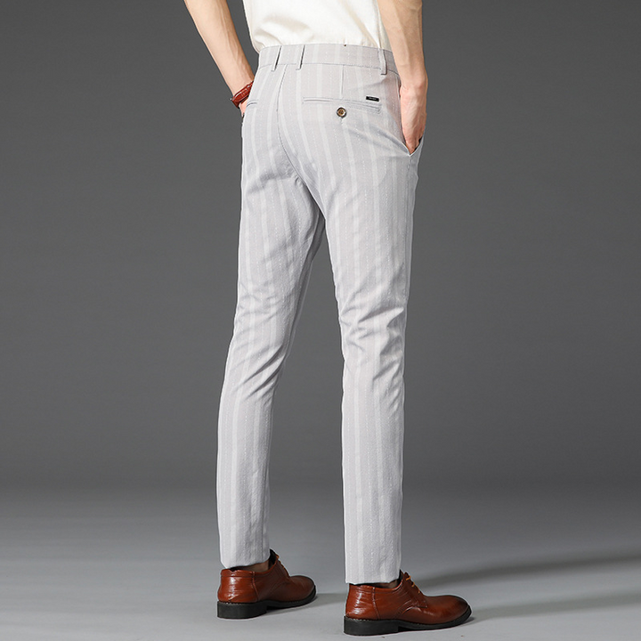 Stylish men's slim fit striped dress pants, suitable for modern office and business attire.