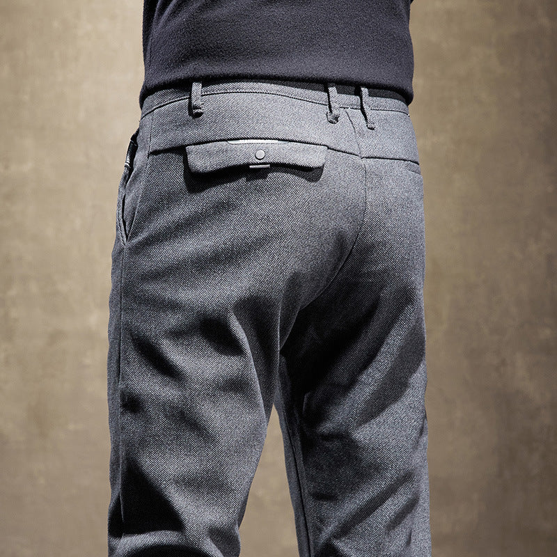 Comfortable waistband and tailored details on men's slim fit pants, perfect for modern office wear.