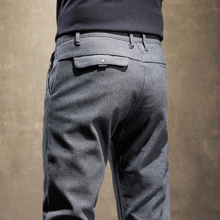 Comfortable waistband and tailored details on men's slim fit pants, perfect for modern office wear.