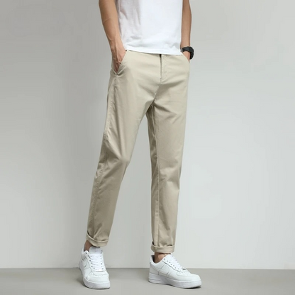 Navy slim-fit tech trousers for men, wrinkle-free & water-resistant.