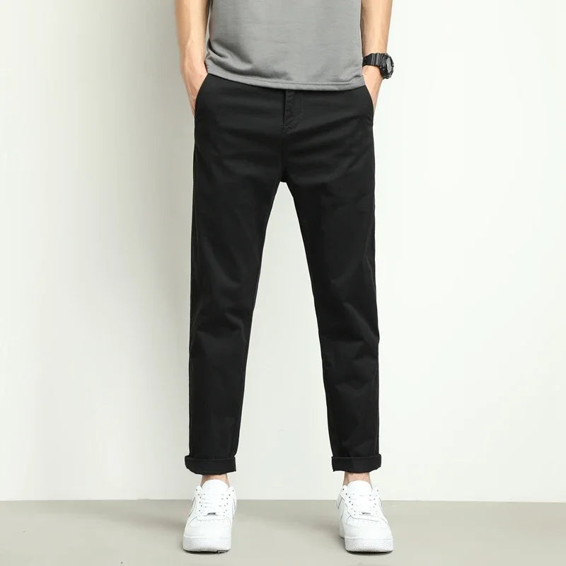 High-performance men's slim-fit trousers, stretch, water-resistant tech.