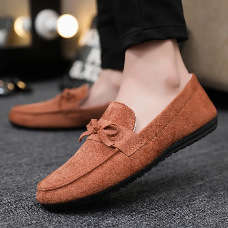 Close-up: Elegant bow detail on men's slip-on loafers. Highlighting sophisticated design & quality.