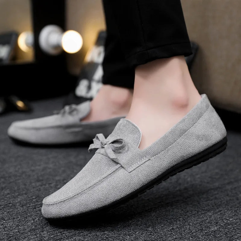 Side profile of men's slip-on bow loafers. Emphasizes sleek design, ultimate comfort, and style.
